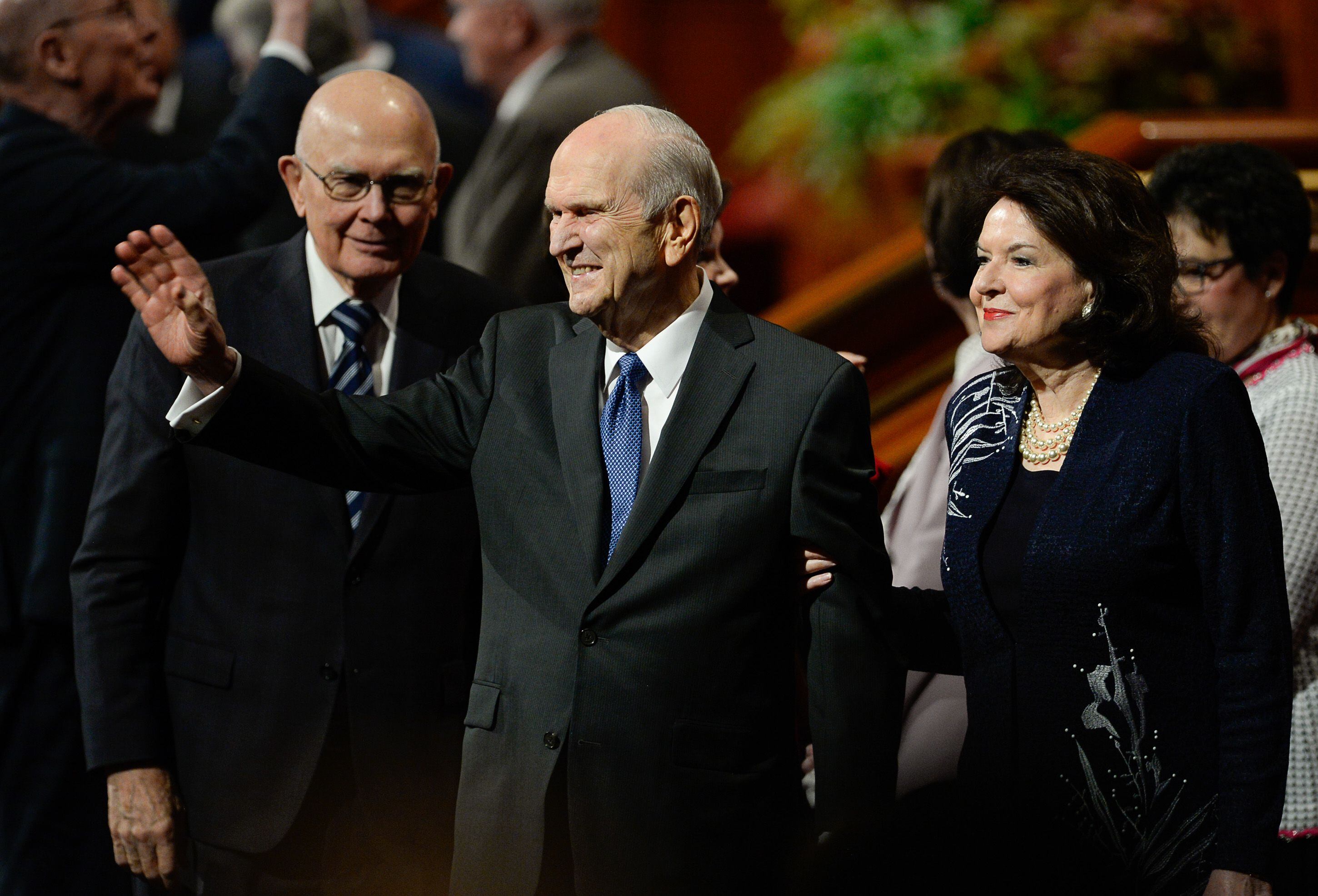 (Francisco Kjolseth | The Salt Lake Tribune) President Russell M. Nelson waves to the crowd as he and his wife, Sister Wendy Nelson, exit at the conclusion of the Sunday morning session of the 189th twice-annual General Conference of The Church of Jesus Christ of Latter-day Saints at the Conference Center in Salt Lake City on Sunday, Oct. 6, 2019. At left is President Dallin H. Oaks, first counselor in the First Presidency of The Church of Jesus Christ of Latter-day Saints