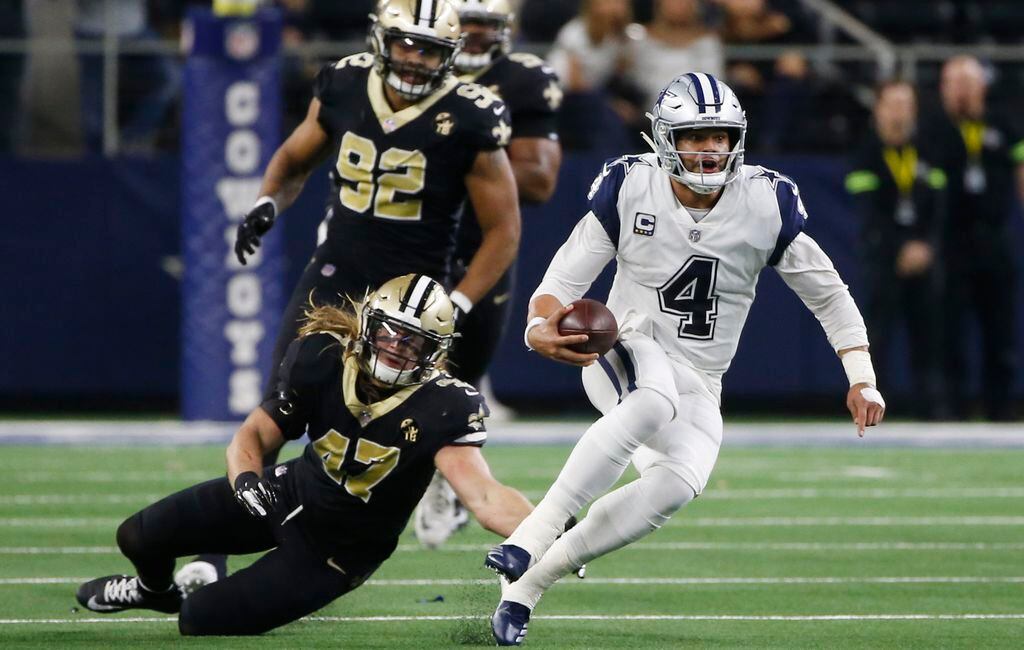 Dallas Cowboys quarterback Dak Prescott (4) scrambles before