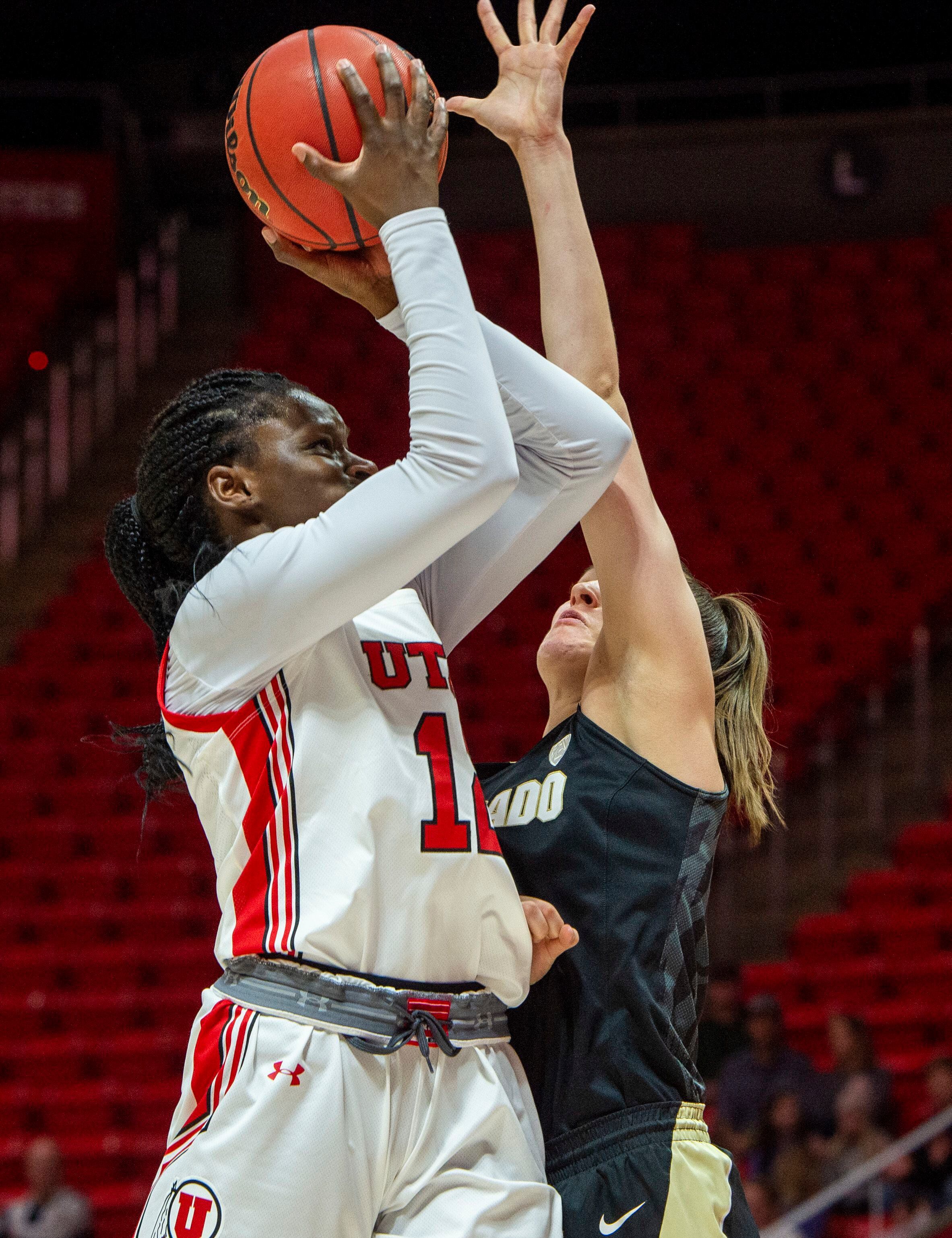 (Rick Egan | The Salt Lake Tribune) Utah Utes forward Lola Pendande (12) shoots, as Colorado Buffaloes guard Emma Clarke (3) defends, in PAC-12 basketball action between the Utah Utes and the Colorado Buffaloes, at the Jon M. Huntsman Center, Sunday, Nov. 29, 2019.