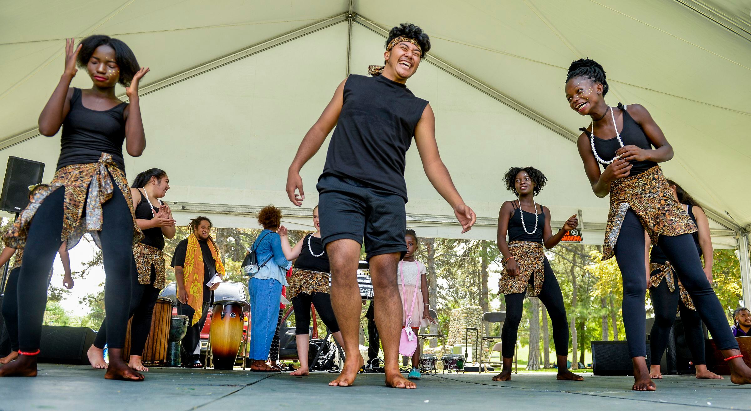 (Leah Hogsten | The Salt Lake Tribune) l-r Benedith Naskiain, Po Hafoka and Judith Gangnon, dancers with Siphya Dance Group, share a laugh during the 4th Annual African Festival sponsored by the United Africans of Utah, Saturday, July 27, 2019 at Liberty Park. The African Festival promotes African tradition, culture and heritage through the arts, food fashion, music and dance.