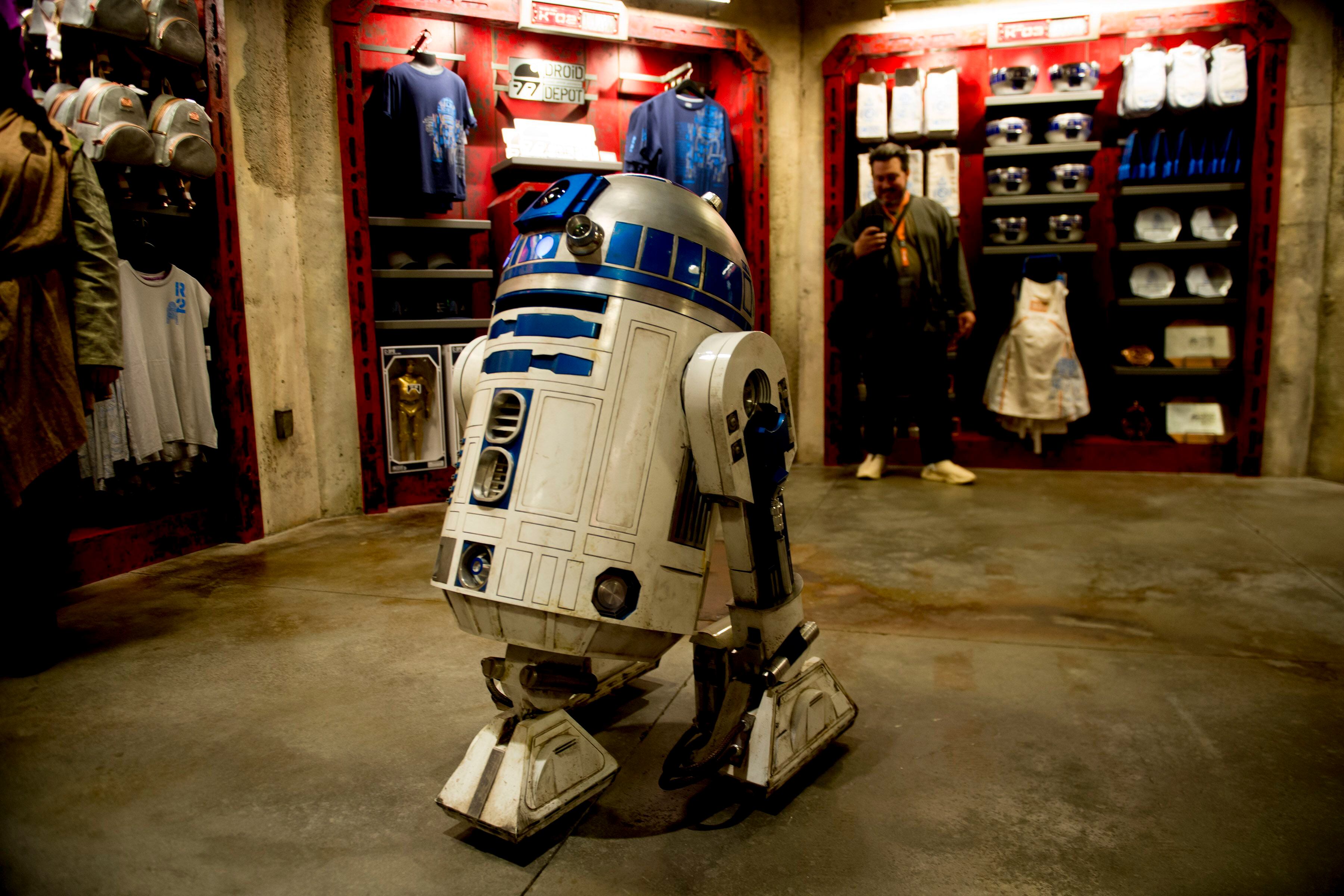 (Jeremy Harmon | The Salt Lake Tribune) R2-D2 holds court in the gift shop at the Droid Depot at Star Wars: Galaxy's Edge in Anaheim, Ca. on Wednesday, May 29, 2019.