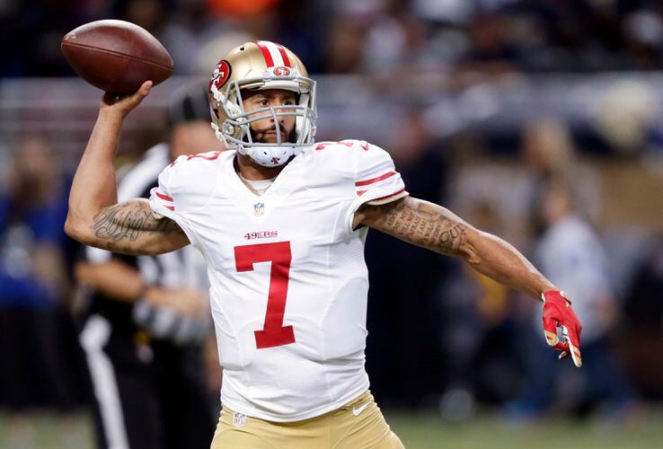 FILE - At left, in a Dec. 24, 2016, file photo, San Francisco 49ers  quarterback Colin Kaepernick talks during a news conference after an NFL  football game against the Los Angeles Rams