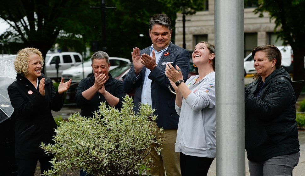 (Francisco Kjolseth | Tribune file photo) In happier times for the Utah Pride Center, Executive Director Rob Moolman, center, cheers the raising of the pride flag over Salt Lake City Hall, May 28, 2019. Then-Salt Lake City Mayor Jackie Biskupskie, left, applauds with Liz Pitts. To Moolman's right are bek Birkett and Hillary McDaniel. Pitts, Birkett and McDaniel all have been laid off from the center in recent weeks.