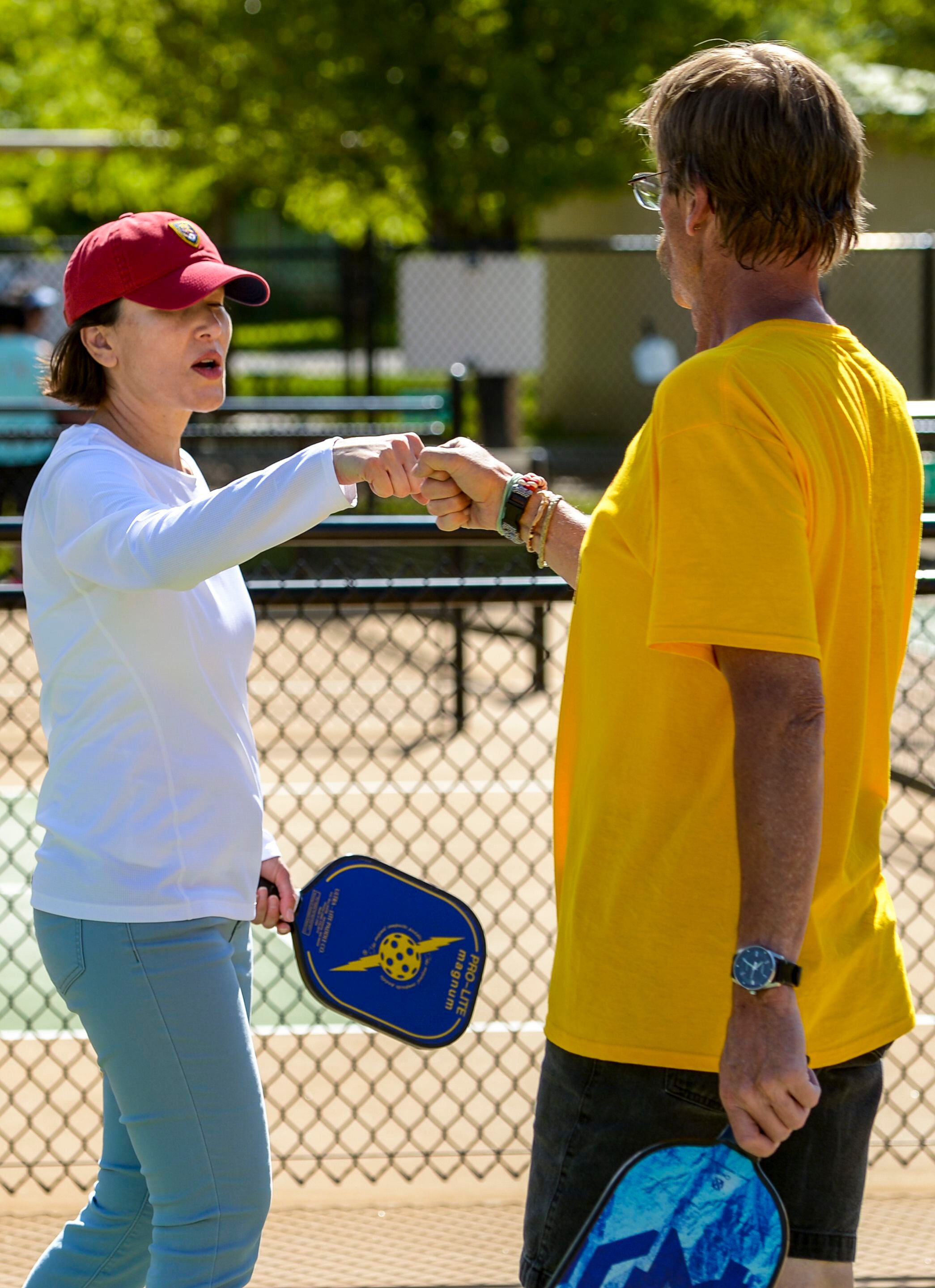 (Leah Hogsten | The Salt Lake Tribune) l-r Veterans Lia Espericueta fist bumps Mark Meacham after a pickleball win at Hogan Park in Bountiful, May 14, 2019. Veteran suicide rates in Utah, are second highest, with the exception of Montana. The non-profit group Continue Mission serves the Veteran population to heal physical, mental, and emotional injuries through recreational programs like pickleball to promote health, mental well-being and positive life changing experiences.