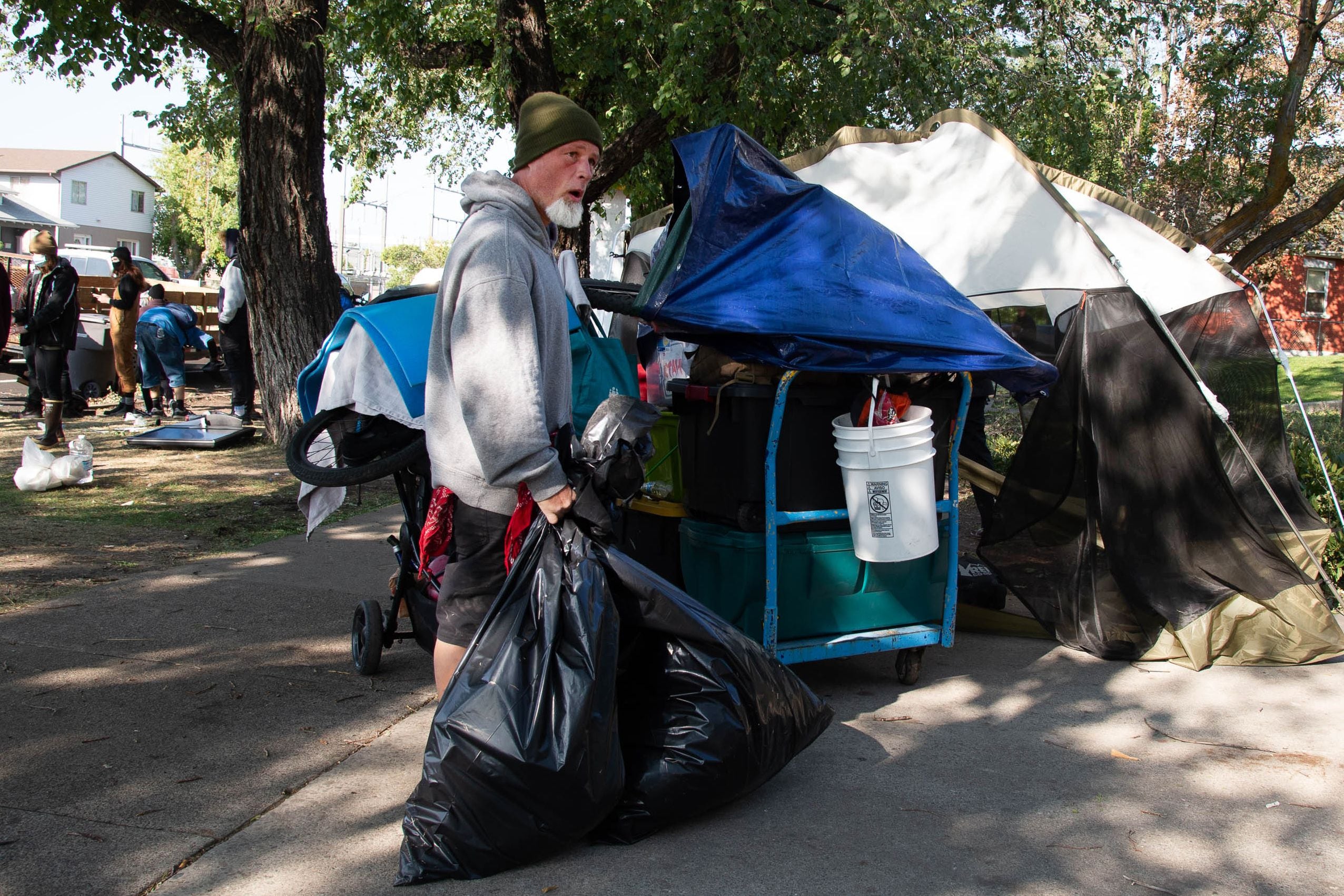 (Francisco Kjolseth | The Salt Lake Tribune) Richard Ryan packs up his belongings as the Salt Lake County Health Department forces a clean up of homeless camps at Taufer Park in Salt Lake City on Thursday, Sept. 10, 2020.