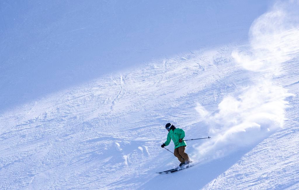 Premium Photo  Skiers sliding down snowy slope on mountain at winter resort
