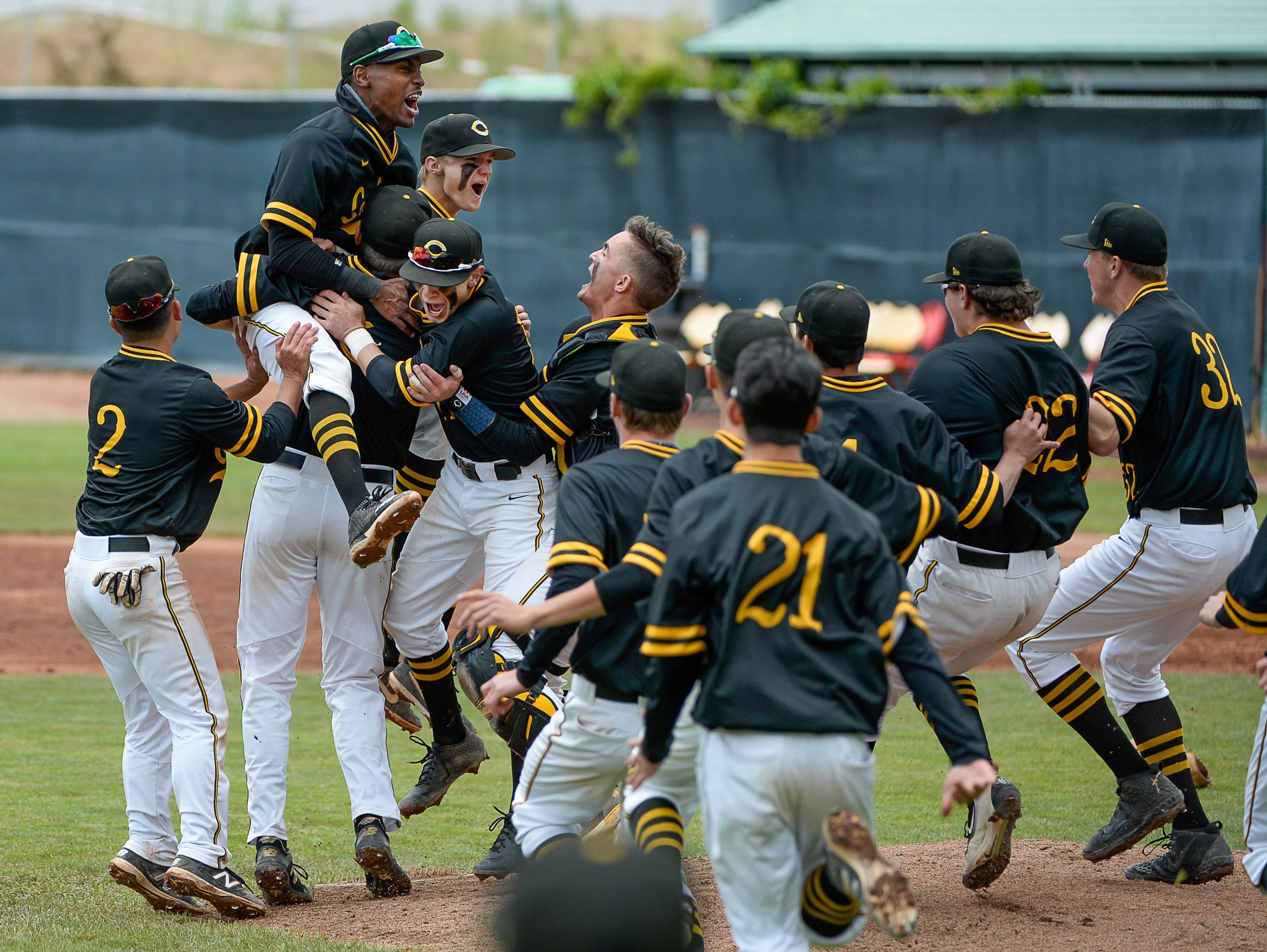 (Francisco Kjolseth | The Salt Lake Tribune) Cottonwood pitcher Carson Angeroth is mobbed by his teammates after striking out Timpanogos 6-5 win during the 5A baseball championship game at UCCU Stadium on the UVU campus in Orem, Friday, May 24, 2019.