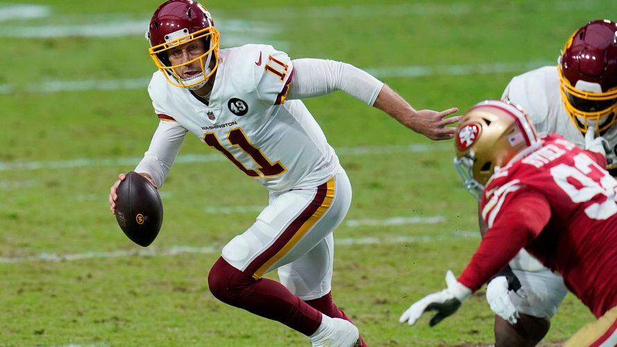 Utah quarterback Alex Smith, left, holds up a San Francisco 49ers