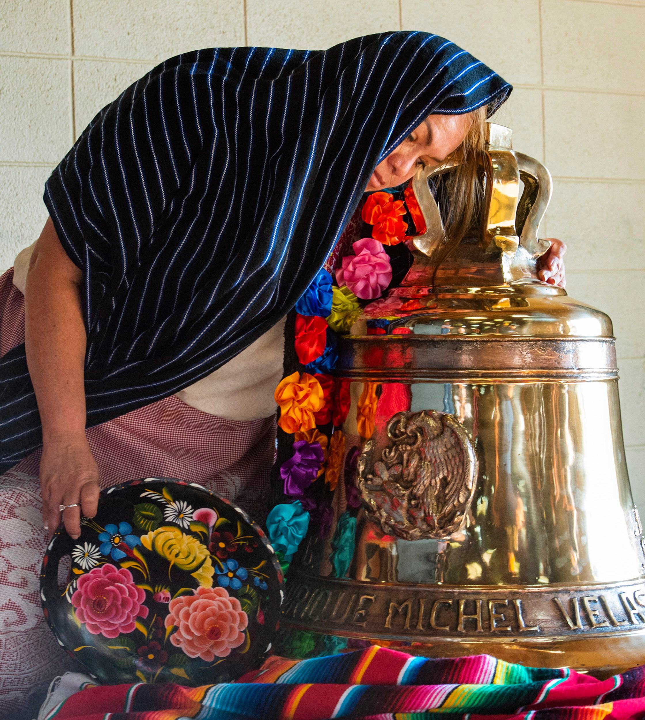 (Rick Egan | The Salt Lake Tribune) Natalia Solache stands with a Symbolic Replica of Mexican Independence Bell, that will be donated to the State of Utah by El Consejo de Comunidades Hispanas A.C. as it arrives in Salt Lake City, Saturday, Aug. 29, 2020. 