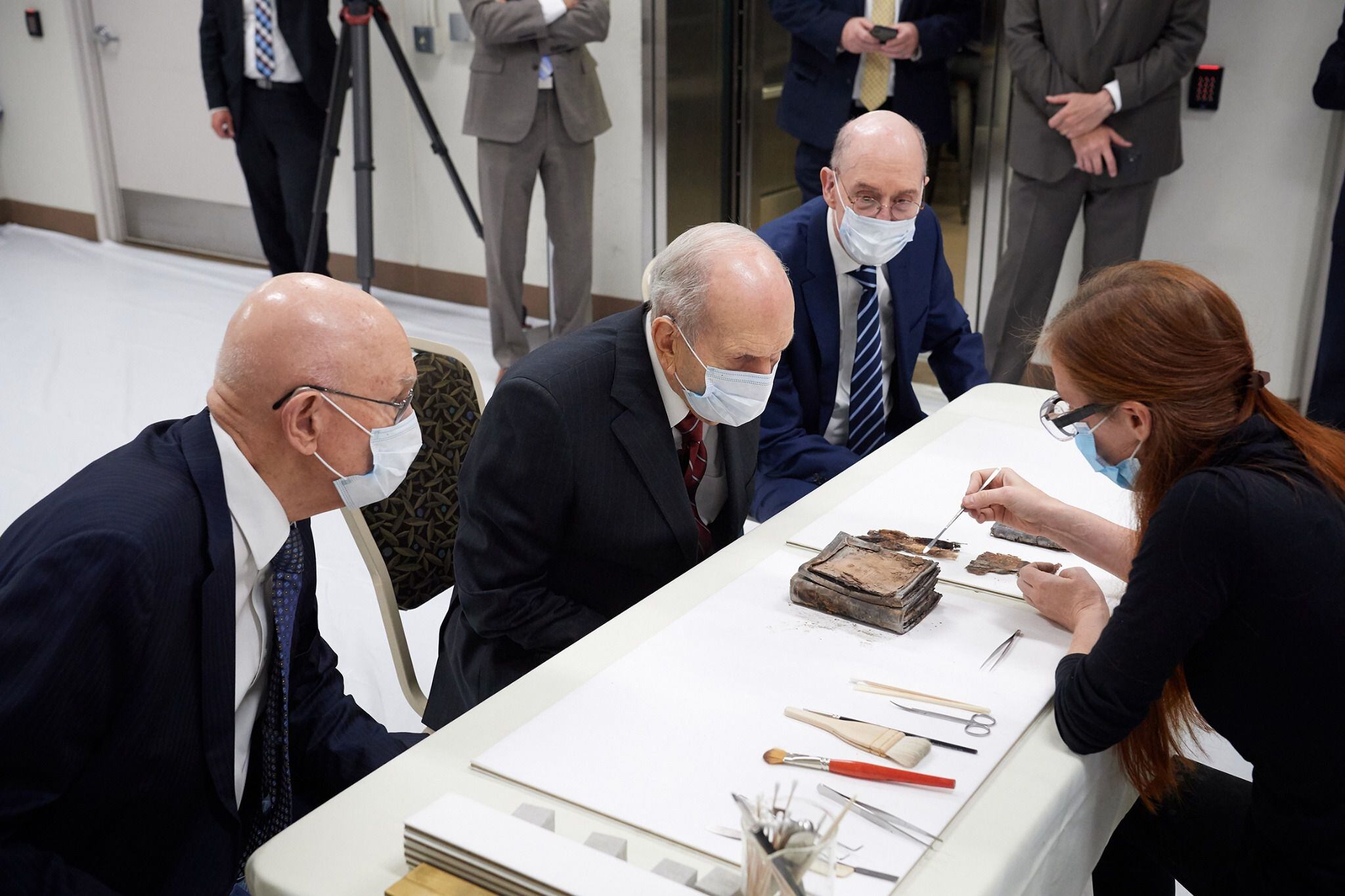 (photo courtesy The Church of Jesus Christ of Latter-day Saints) Emiline Twitchell, a conservator at the Church History Library, shows contents from the capstone of the Salt Lake Temple to the First Presidency on May 20, 2020.