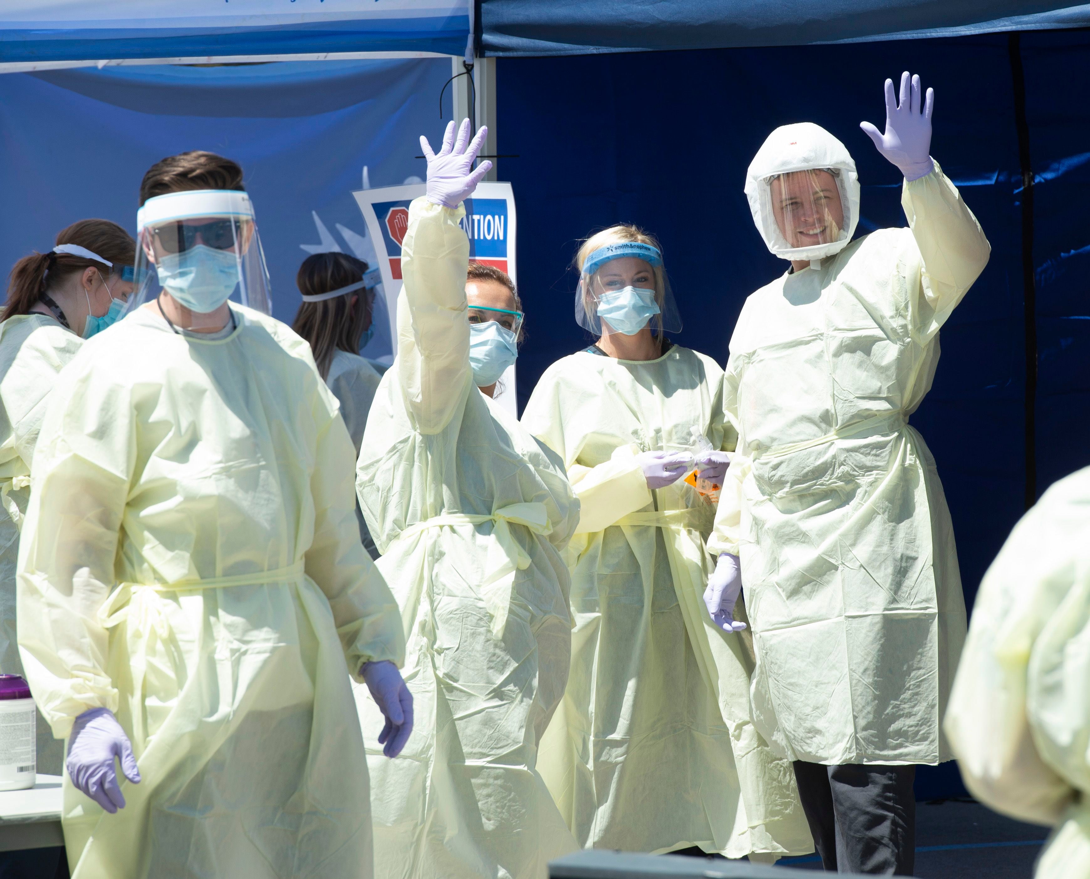 (Rick Egan | The Salt Lake Tribune) Medical assists motion that they are ready for the next patient, at the Intermountain Healthcare Coronavirus Mobile Testing Unit at Utah Valley Hospital in Provo, Friday May 8, 2020.