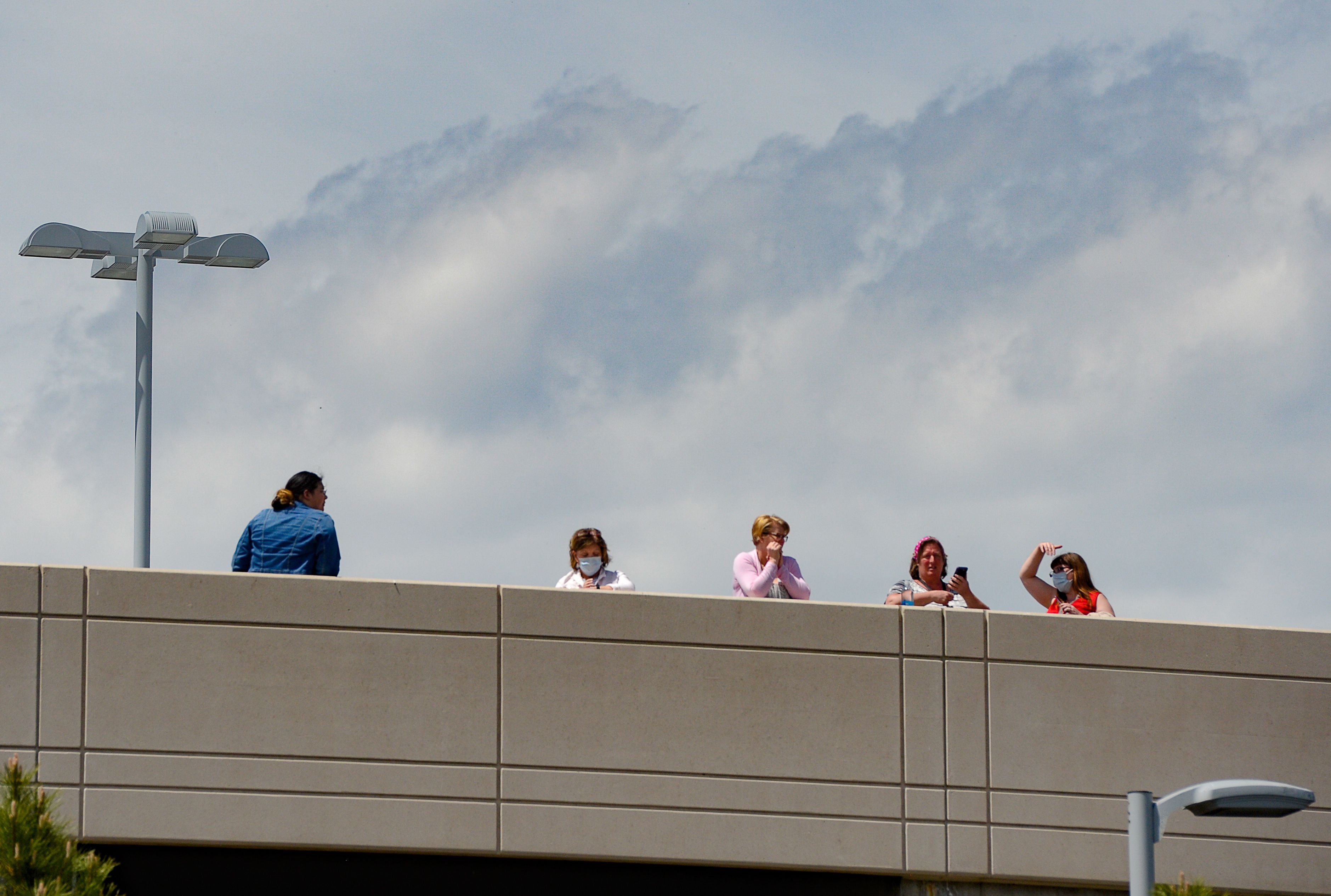 (Francisco Kjolseth | The Salt Lake Tribune) People gather on the rooftop of Intermountain Medical Center in Murray in anticipation of a flyover by the Air Force F-35A Lightning II Demonstration and 388th Fighter Wing, based at Hill Air Force Base, on Thursday, April 30, 2020. The demonstration over Utah was a "salute to everyone on the front lines in the fight against COVID-19, as well as those staying at home to flatten the curve of the virus," according to a news release.