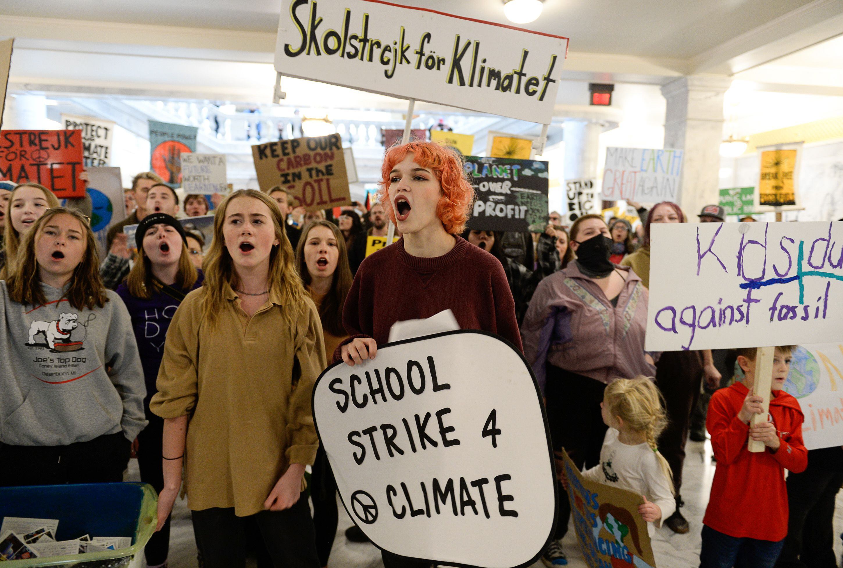 (Francisco Kjolseth | The Salt Lake Tribune) Aurora Laird, center, joins Nina Serafin, center left, along with numerous other students as they chant "this is what democracy looks like!" as they gather outside the office of Gov. Gary Herbert on the Utah Capitol on Friday, Dec. 6, 2019, in an effort to deliver over 4,000 written cards with the importance of protecting Utah lands and clean air solutions. Fridays For Future, Utah Youth Environmental Solutions, and partners strike in opposition to Utah’s final oil and gas lease sale of 2019 that will auction off public lands and further fossil fuel development.