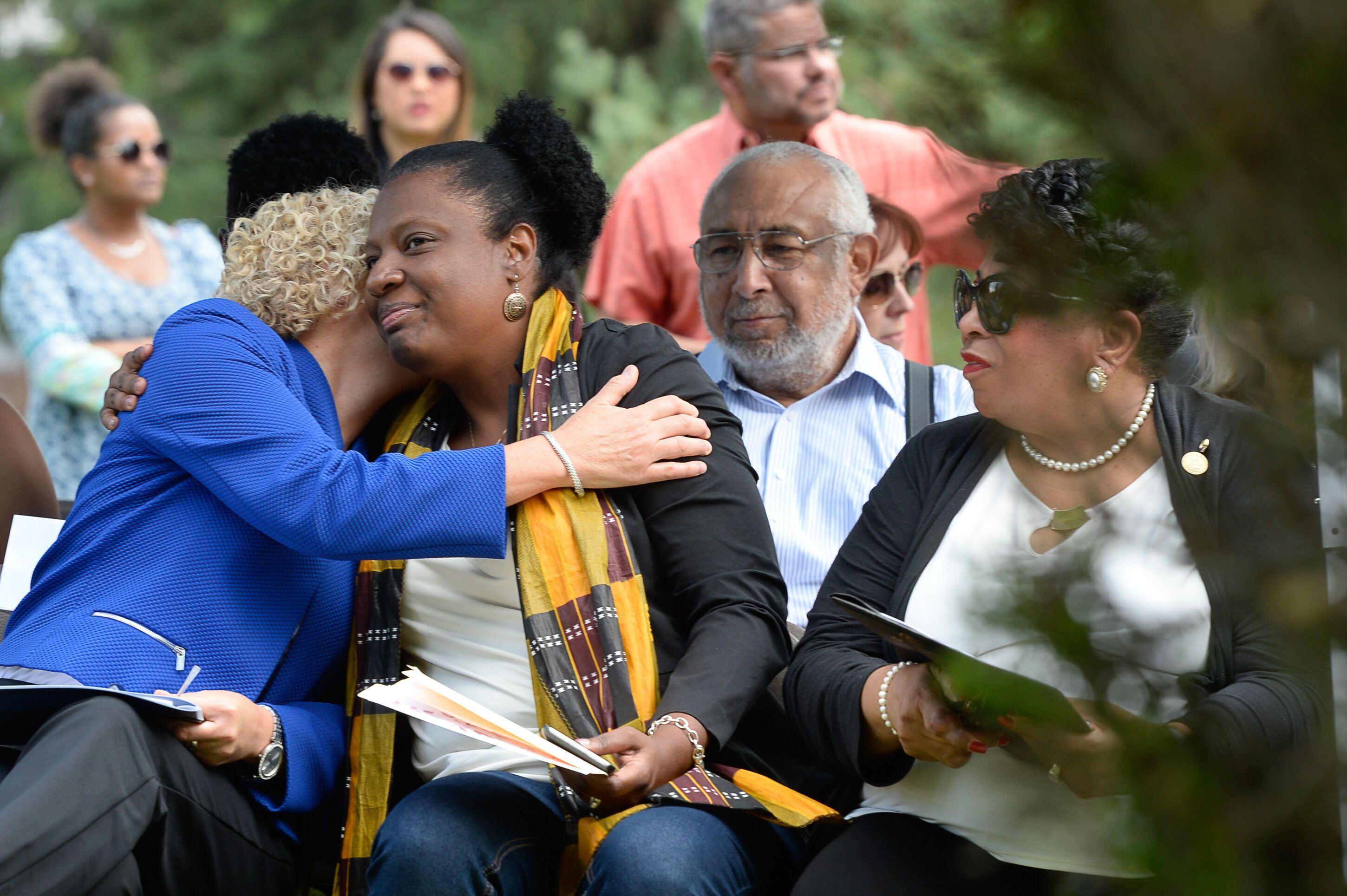 (Francisco Kjolseth | The Salt Lake Tribune) Mayor Jackie Biskupski, left, embraces Rep. Sandra Hollins, D-Salt Lake, alongside Jeanetta Williams, NAACP President as they attend a grave marker dedication at the Salt Lake City Cemetery for Tom, an enslaved Black pioneer who was buried in the Salt Lake City Cemetery in 1862. The placement and dedication of the marker on Thursday, Aug. 22, 2019, is the result of research initially conducted by Mark Smith, the former sexton of the Cemetery.