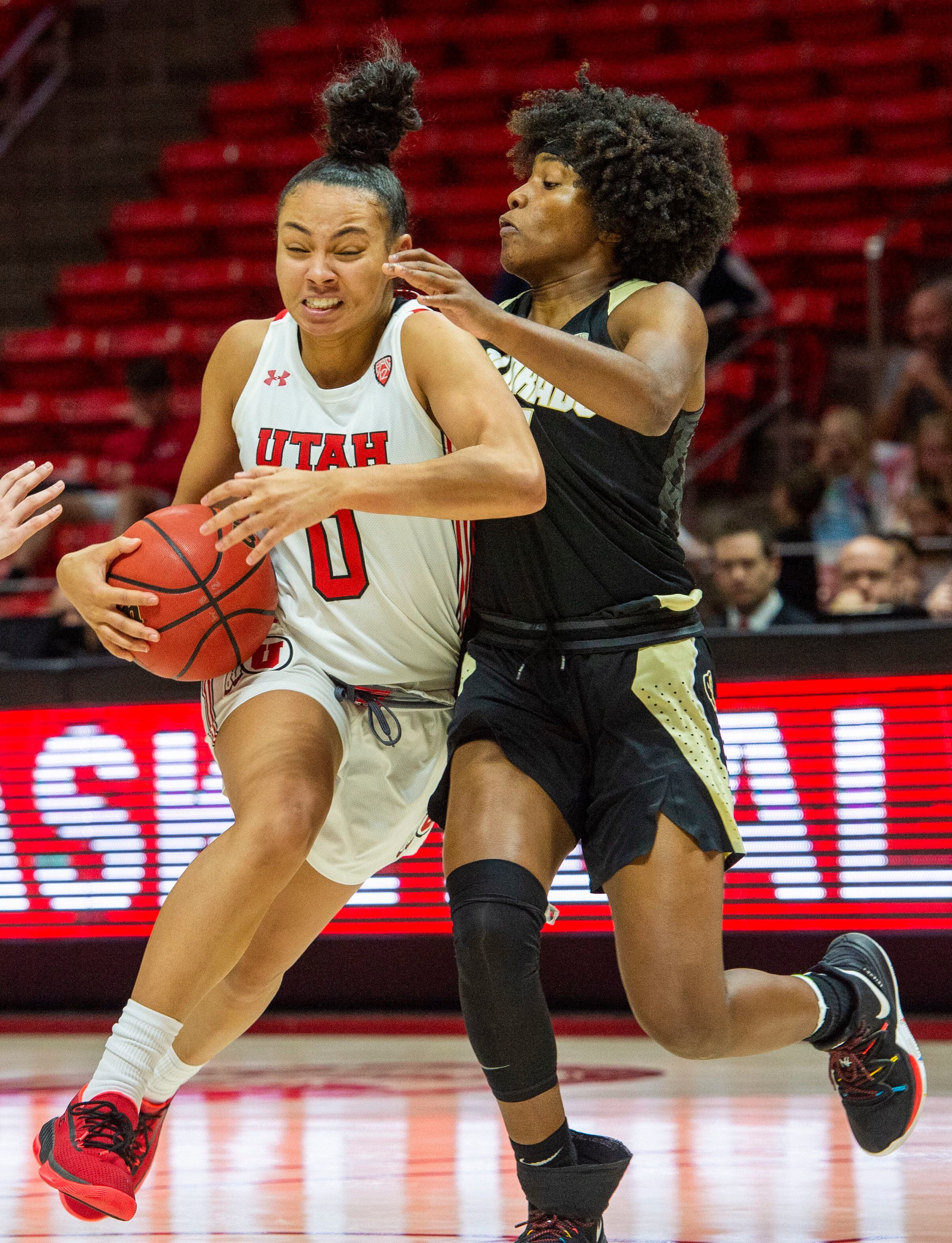 (Rick Egan | The Salt Lake Tribune) Utah Utes guard Kiana Moore (0) takes the ball down court, as Colorado Buffaloes guard Jaylyn Sherrod (1) defends, in PAC-12 basketball action between the Utah Utes and the Colorado Buffaloes, at the Jon M. Huntsman Center, Sunday, Nov. 29, 2019.