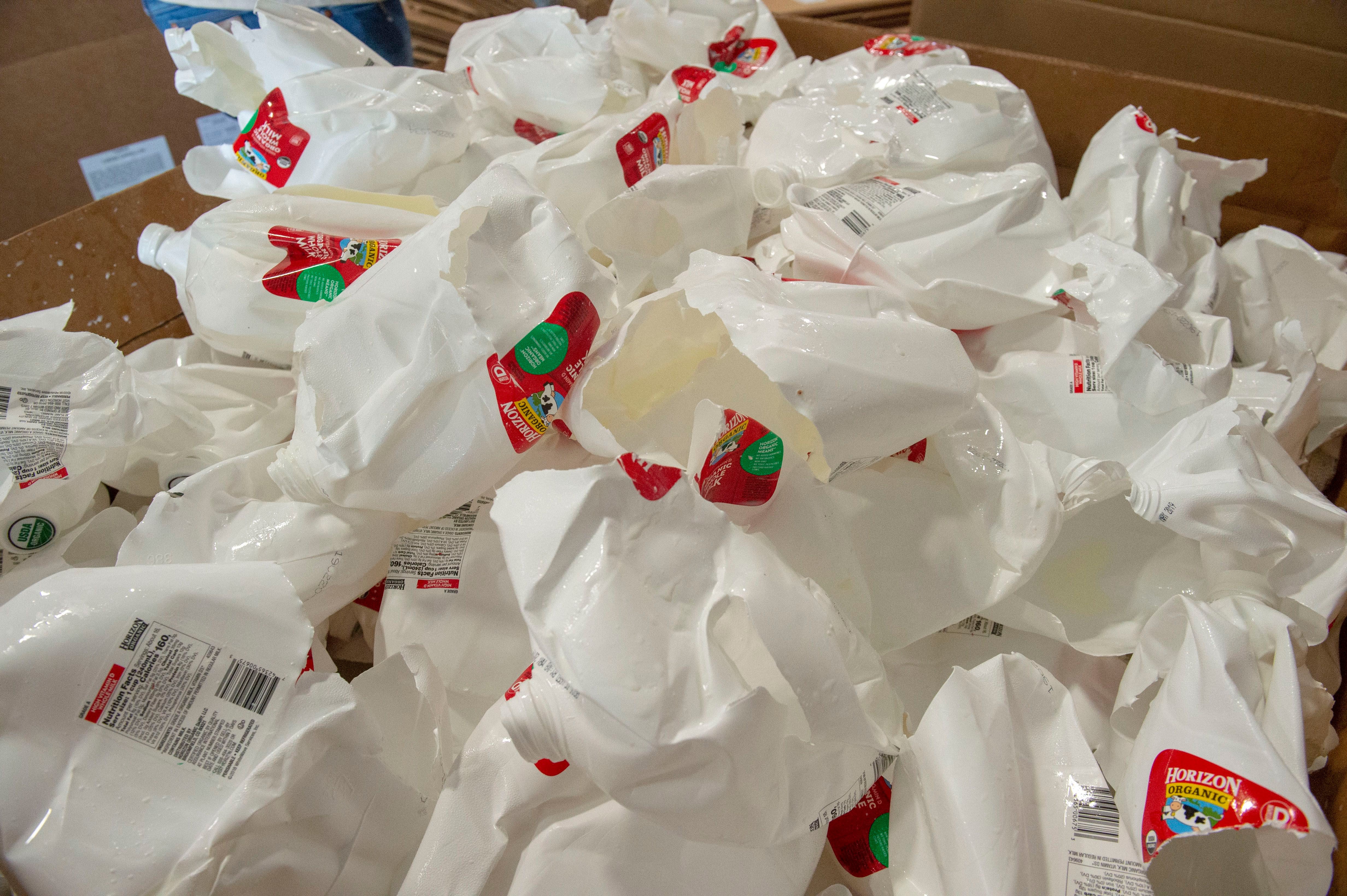 (Rick Egan | The Salt Lake Tribune) Empty milk containers come out of the de-bottling machine at Wasatch Resource Recovery in North Salt Lake. Friday, May 24, 2019.