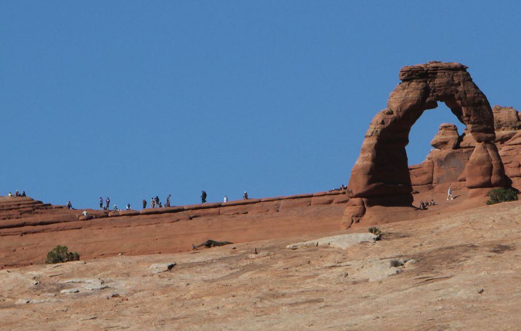 Francisco Kjolseth | The Salt Lake Tribune Visitors get a close up view of Delicate Arch at Arches National Park in southern Utah recently. The infrastructure of Arches National Park was created based on an annual average visitation of 75,000. The park surpassed 1 million visitors in 2010 and is steadily climbing. Officials at Arches are considering options to reduce the number of cars in the park and a shuttle system is one option. However, it would be expensive and, if visitation numbers keep going up, it could soon be obsolete.