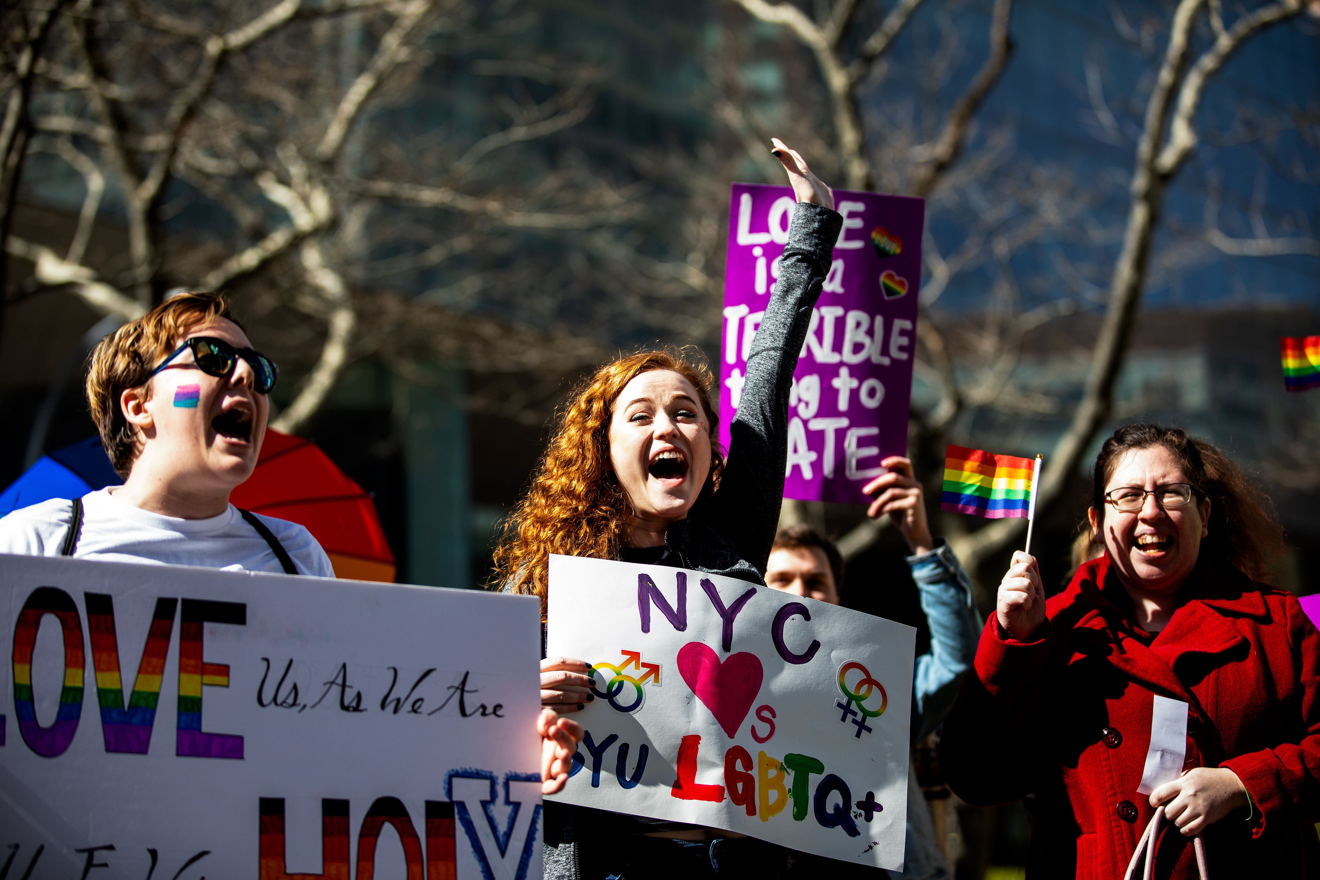 (Demetrius Freeman | for The Salt Lake Tribune) Maddie Hall, 25, center, chant with current and former members of the Church of Jesus Christ of Latter-day Saints, the LGBTQ+ community, and supporters gather at Lincoln square across from the Mormon temple in Manhattan, New York , on Saturday, March 7, 2020, to stand in solidarity with LGBTQ+ students who attending Brigham Young University. Brigham Young University reinstated homophobic policies in their student handbook that prohibit Òhomosexual behavior.Ó