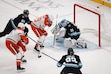 Anaheim Ducks right wing Troy Terry (19) shoots as defenseman Jackson LaCombe (2) assists while Utah Hockey Club goaltender Jaxson Stauber (33) defends with defenseman Ian Cole (28) and center Logan Cooley (92) during the second period of an NHL hockey game, Sunday, Dec. 22, 2024, in Salt Lake City. (AP Photo/Bethany Baker)