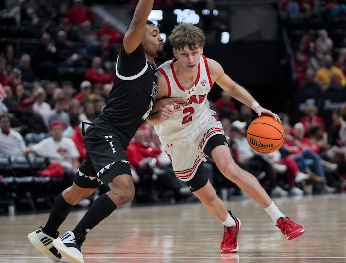 (Bethany Baker  |  The Salt Lake Tribune) Utah Utes guard Cole Bajema (2) drives to the basket as Hawaii Warriors guard JoVon McClanahan (3) defends at the Delta Center in Salt Lake City on Thursday, Nov. 30, 2023.