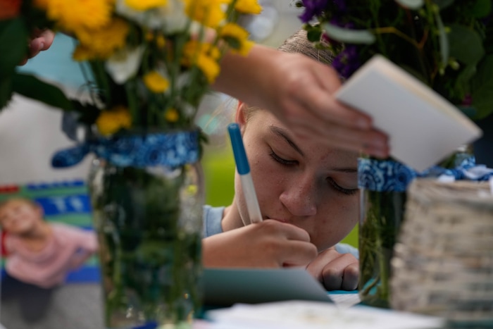 (Francisco Kjolseth  |  The Salt Lake Tribune) People write notes to Adlai Owen during a memorial at Laird Park in Salt Lake City on Wednesday, May 22, 2024. Police say Adlai’s father, Sam Owen, fatally shot Adlai before killing himself in an apparent murder-suicide on Saturday, May 18, 2024.