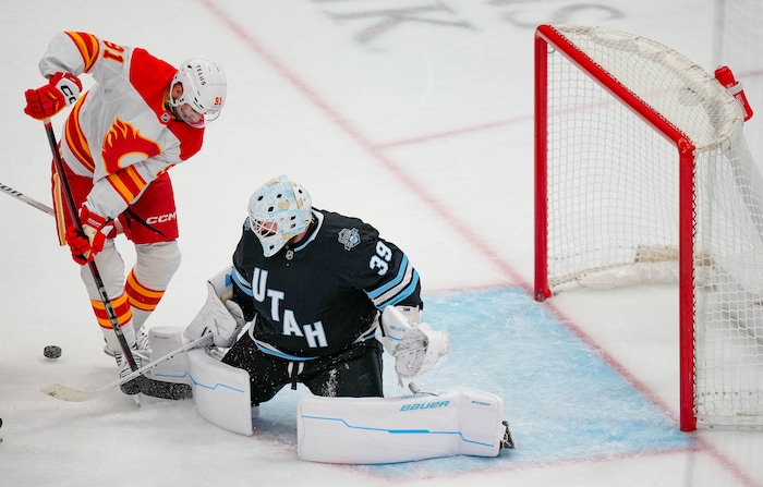 (Francisco Kjolseth  | The Salt Lake Tribune) Calgary Flames center Nazem Kadri (91) tries to get past Utah Hockey Club goaltender Connor Ingram (39) during an NHL hockey game at the Delta Center in Salt Lake City on Wednesday, Oct. 30, 2024. Utah won 5-1.