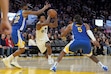 Utah Jazz guard Collin Sexton (2) drives to the basket against Golden State Warriors forward Andrew Wiggins (22) and forward Kevon Looney (5) during the second half of an NBA basketball game in San Francisco, Tuesday, Jan. 28, 2025. (AP Photo/Jeff Chiu)