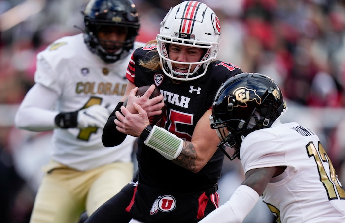 (Bethany Baker  |  The Salt Lake Tribune) Utah Utes quarterback Luke Bottari (15) runs the ball for a touchdown as Colorado Buffaloes cornerback Travis Hunter (12) defends at Rice-Eccles Stadium in Salt Lake City on Saturday, Nov. 25, 2023.