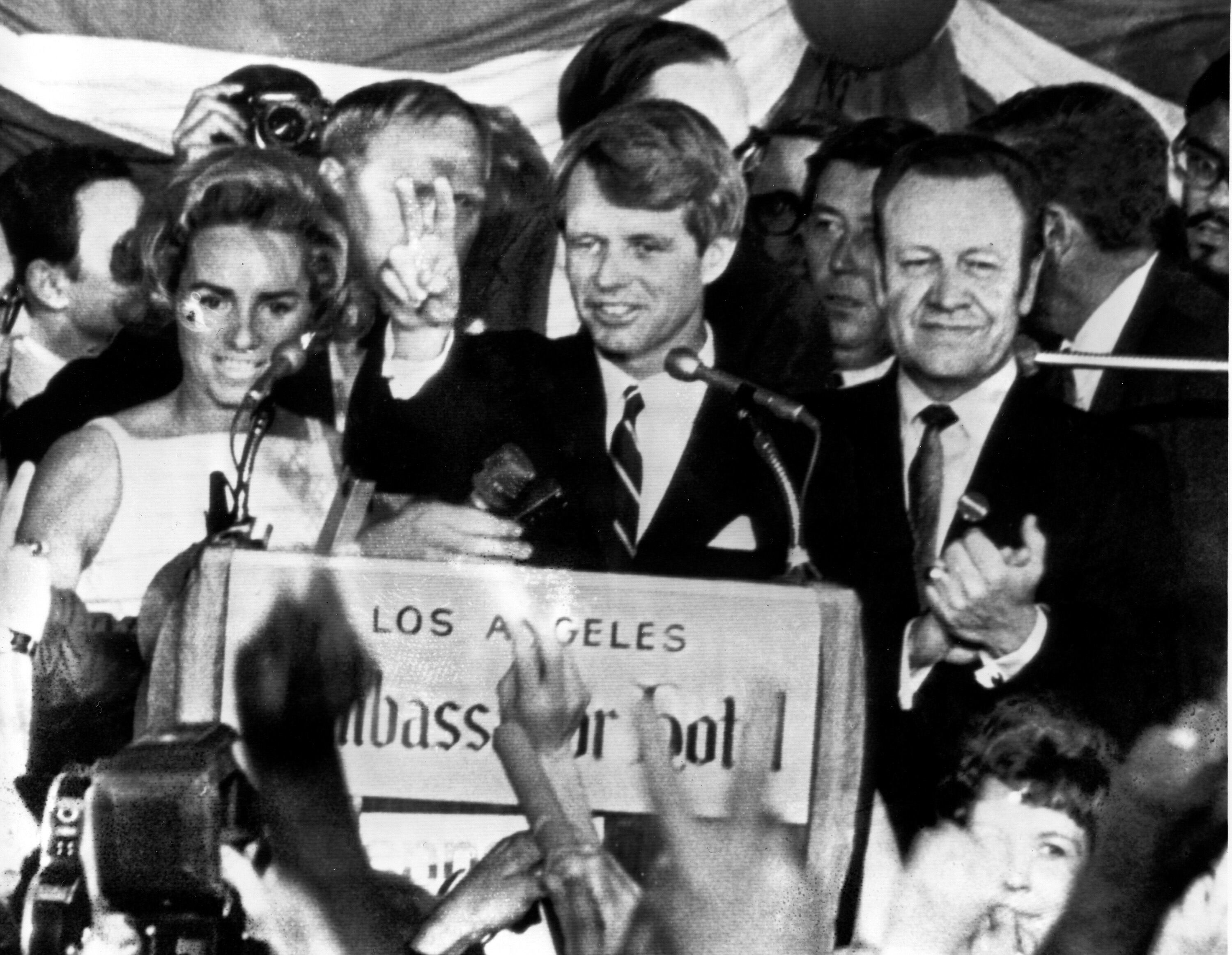 (AP) In this June 5, 1968, photograph, U.S. Sen. Robert F. Kennedy, D-N.Y., speaks to campaign workers as his wife Ethel, left, and California campaign manager and speaker of the California Assembly, Jesse Unruh, look on, at the Ambassador Hotel in Los Angeles. After making a short speech, Kennedy was shot in an adjacent room and died the next day.