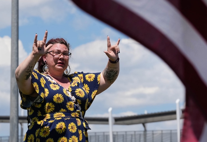 (Francisco Kjolseth  |  The Salt Lake Tribune) Breanna Davis, who’s father used to be an Orem police officer, joins others mourning the loss of Santaquin police Sgt. Bill Hooser following services at the UCCU Center at Utah Valley University on Monday, May 13, 2024.