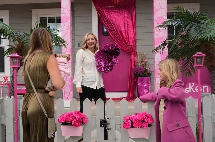 (Bethany Baker  |  The Salt Lake Tribune) Deidra Smith, left, talks with her neighbor Jamie Tucker, center, about additional home decorations in a section of Daybreak that has collectively created a Barbieland-themed community for Halloween on Wednesday, Oct. 11, 2023.