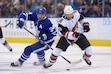 Toronto Maple Leafs center Auston Matthews (34) and Arizona Coyotes right wing Vinnie Hinostroza (13) battle for the puck during first period NHL hockey action in Toronto on Tuesday Feb. 11, 2020. (Nathan Denette/The Canadian Press via AP)