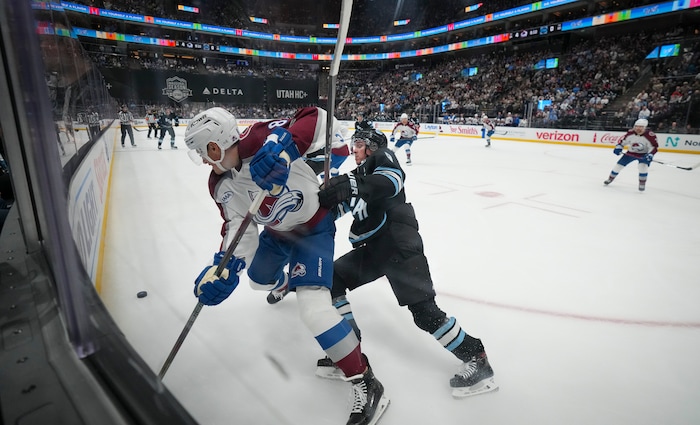 (Bethany Baker  |  The Salt Lake Tribune) Utah Hockey Club center Clayton Keller (9) and Colorado Avalanche defenseman Cale Makar (8) vie for the puck during the game between the Utah Hockey Club and the Colorado Avalanche at the Delta Center in Salt Lake City on Thursday, Oct. 24, 2024.