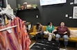 (Bethany Baker  |  The Salt Lake Tribune) Dean Mauchley, right, speaks as Ruth Gonzalez-Muhlestein, center, and Sadie Croker, left, listen at Mosaics Community Bookstore & Venue in Provo.