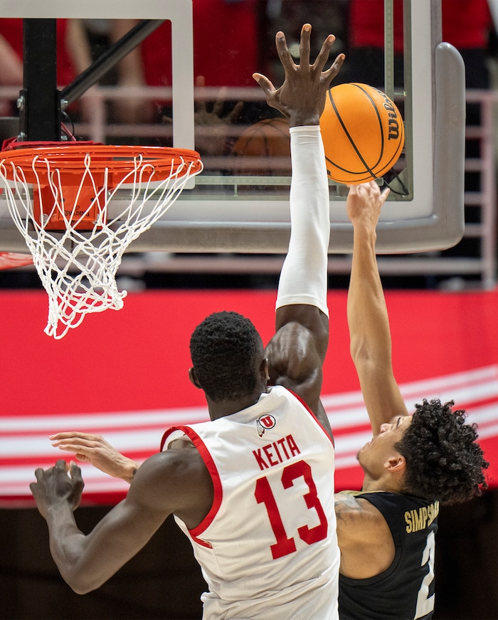 (Rick Egan | The Salt Lake Tribune) Utah Utes center Keba Keita (13) blocks a shot by Colorado Buffaloes guard KJ Simpson (2), in PAC-12 basketball action between the Utah Utes and the Colorado Buffaloes a the Jon M. Huntsman Center, on Saturday, Feb. 3, 2024.
