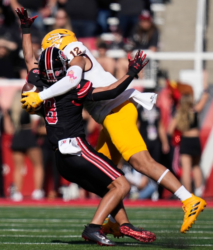 (Francisco Kjolseth  |  The Salt Lake Tribune) Utah Utes safety Cole Bishop (8) gets sandwiched between the ball and Arizona State Sun Devils tight end Jalin Conyers (12) in NCAA football in Salt Lake City on Saturday, Nov. 4, 2023.