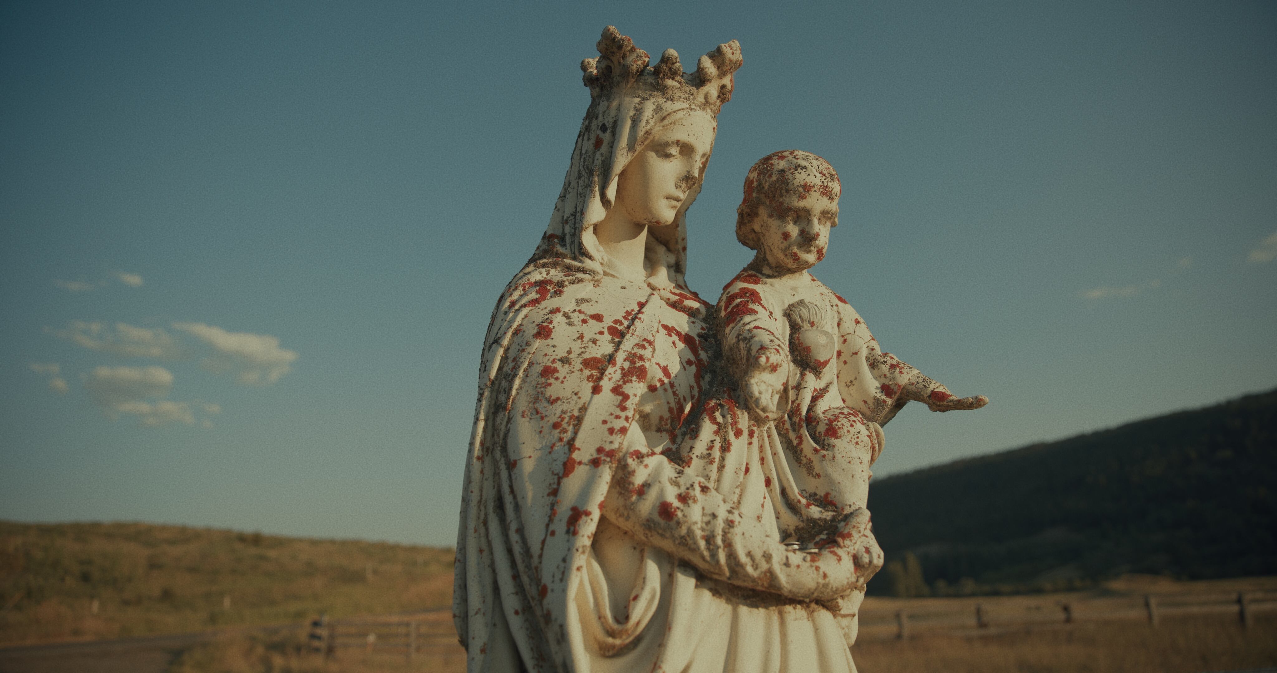 (Christopher LaMarca | Sugarcane Film LLC) A statue of Mary and Baby Jesus looks over St. Joseph's Mission, a former Indian residential school near Williams Lake, British Columbia, where a search for unmarked graves of former students is underway.