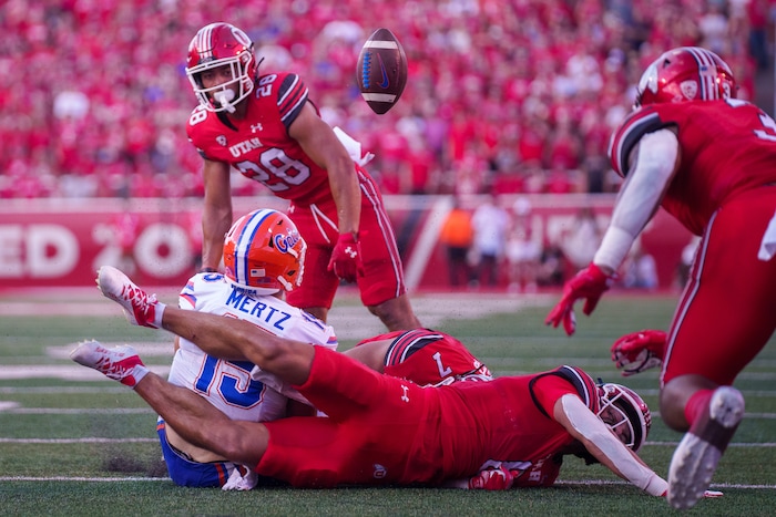 (Trent Nelson  |  The Salt Lake Tribune) Florida Gators quarterback Graham Mertz (15) loses the ball after a hit from Utah Utes safety Cole Bishop (8) as the Utah Utes host the Florida Gators, NCAA football in Salt Lake City on Thursday, Aug. 31, 2023.