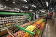 (Ted S. Warren | Associated Press) In this Feb. 21, 2020 photo, a worker checks items on a shelf in the produce section of a grocery store.