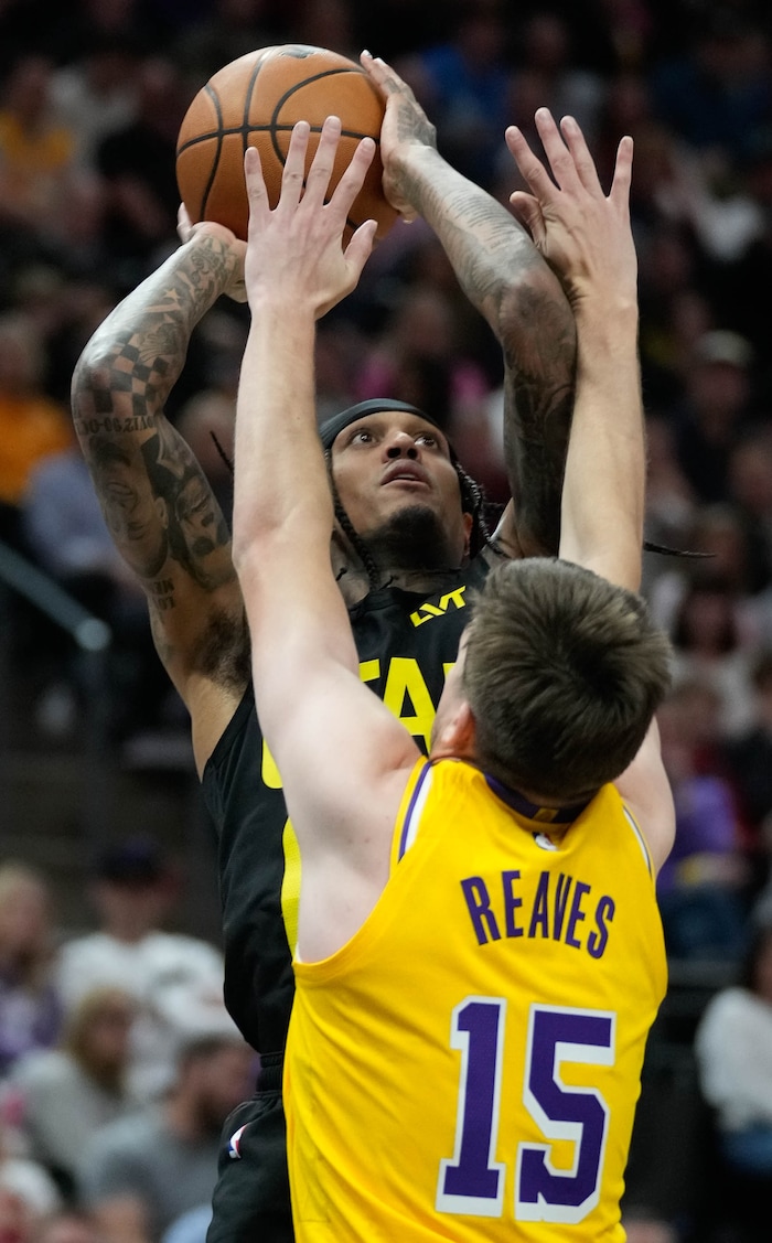 (Francisco Kjolseth  |  The Salt Lake Tribune) Utah Jazz guard Jordan Clarkson (00) makes a shot over Los Angeles Lakers guard Austin Reaves (15) during an NBA basketball game Wednesday, Feb. 14, 2024, in Salt Lake City.