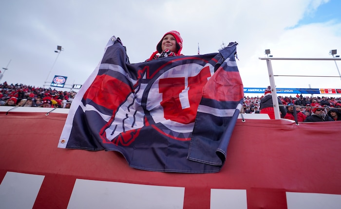 (Bethany Baker  |  The Salt Lake Tribune) A Utah Utes fan holds a flag during the game against the Colorado Buffaloes at Rice-Eccles Stadium in Salt Lake City on Saturday, Nov. 25, 2023.