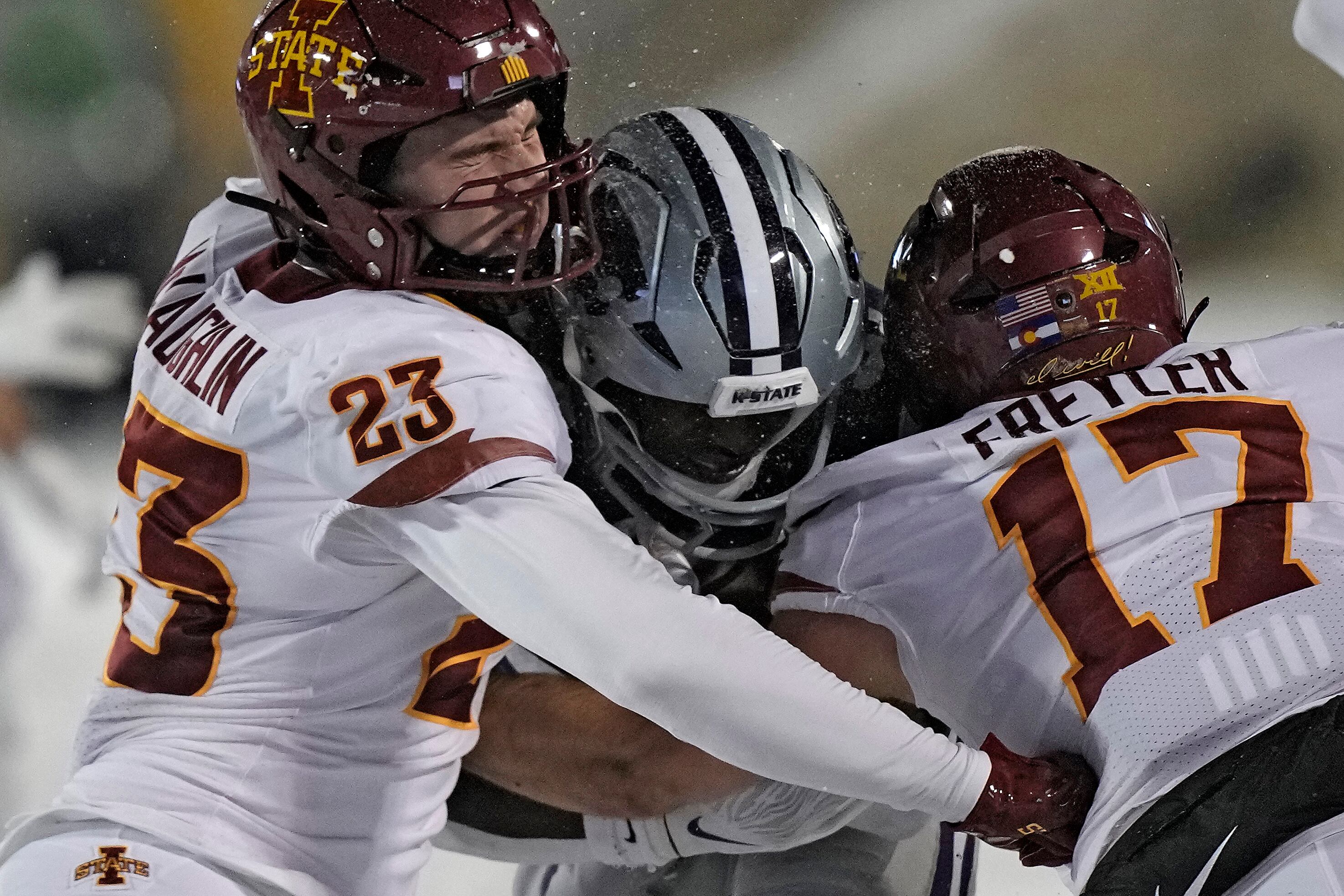 Kansas State running back DJ Giddens, center, it tackled by Iowa State linebacker Will McLaughlin (23) and defensive back Beau Freyler (17) during the second half of an NCAA college football game Saturday, Nov. 25, 2023, in Manhattan, Kan. Iowa State won 42-35. (AP Photo/Charlie Riedel)