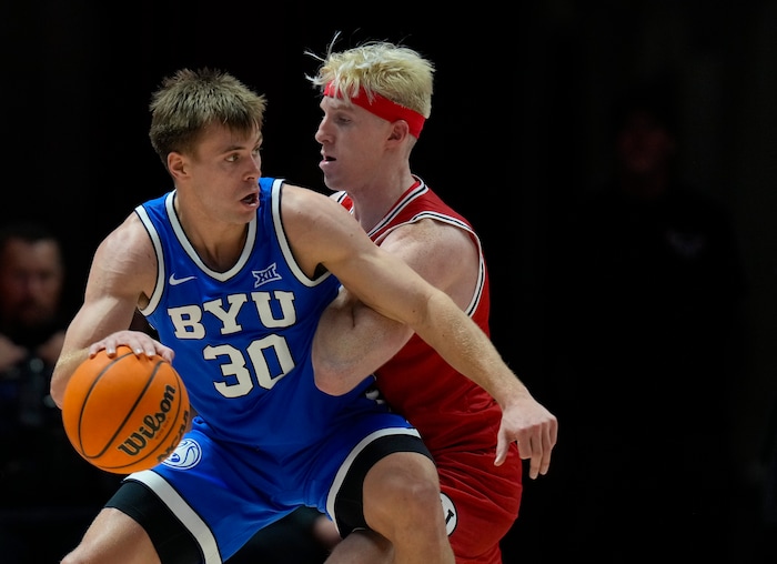 (Bethany Baker  |  The Salt Lake Tribune) Brigham Young Cougars guard Dallin Hall (30) dribbles to the basket as Utah Utes guard Hunter Erickson (0) defends at the Jon M. Huntsman Center in Salt Lake City on Saturday, Dec. 9, 2023.