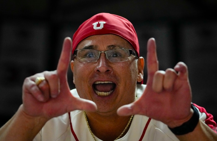 (Bethany Baker  |  The Salt Lake Tribune) A Utah Utes fans cheers during the game against the Brigham Young Cougars at the Jon M. Huntsman Center in Salt Lake City on Saturday, Dec. 9, 2023.