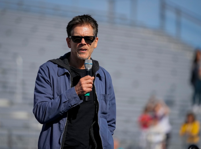 (Bethany Baker  |  The Salt Lake Tribune) Kevin Bacon speaks at a charity event to commemorate the 40th anniversary of the movie "Footloose" on the football field of Payson High School in Payson on Saturday, April 20, 2024.