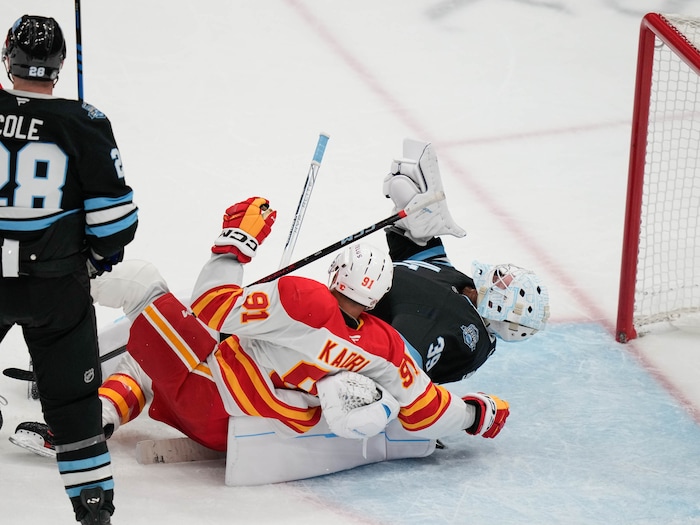 (Francisco Kjolseth  | The Salt Lake Tribune) Calgary Flames center Nazem Kadri (91) collides with Utah Hockey Club goaltender Connor Ingram (39) during an NHL hockey game at the Delta Center in Salt Lake City on Wednesday, Oct. 30, 2024.