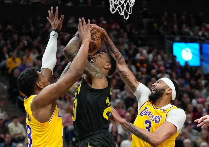 (Francisco Kjolseth  |  The Salt Lake Tribune) Utah Jazz forward John Collins (20) is blocked by Los Angeles Lakers forward Rui Hachimura (28) and Los Angeles Lakers forward Anthony Davis (3) during an NBA basketball game Wednesday, Feb. 14, 2024, in Salt Lake City.