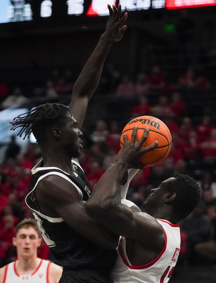 (Bethany Baker  |  The Salt Lake Tribune) Hawaii Warriors center Mor Seck (23) blocks as Utah Utes center Keba Keita (13) looks to shoot at the Delta Center in Salt Lake City on Thursday, Nov. 30, 2023.
