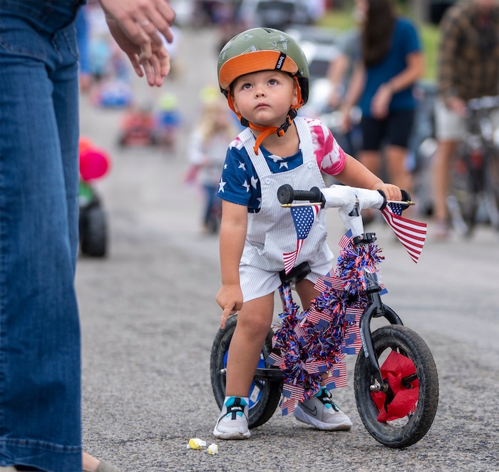 (Rick Egan | The Salt Lake Tribune)  A young bicyclist stops to ask for help picking up a piece of candy, during the Liberty Days Parade in Liberty, Utah, on Tuesday, July 4, 2023.   