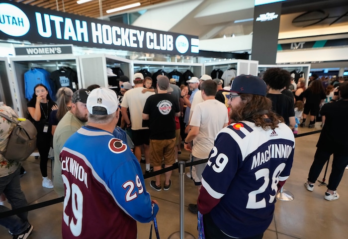 (Francisco Kjolseth  |  The Salt Lake Tribune) David Groves and Tyler Gulbransen join the fun while people purchase merchandise as the Utah Hockey Club hosts their first NHL draft party at the Delta Center on Friday, June 28, 2024.